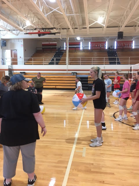 NYHS volleyball team took some time away from training to play volleyball with Mech-Kar participants.